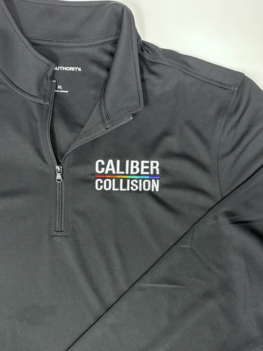Embroidered quarter-zip prepared for a branded apparel program